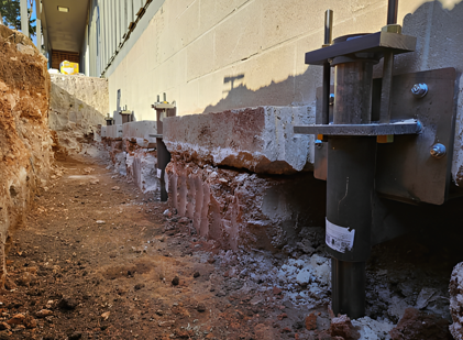 A concrete wall is being built next to a brick wall