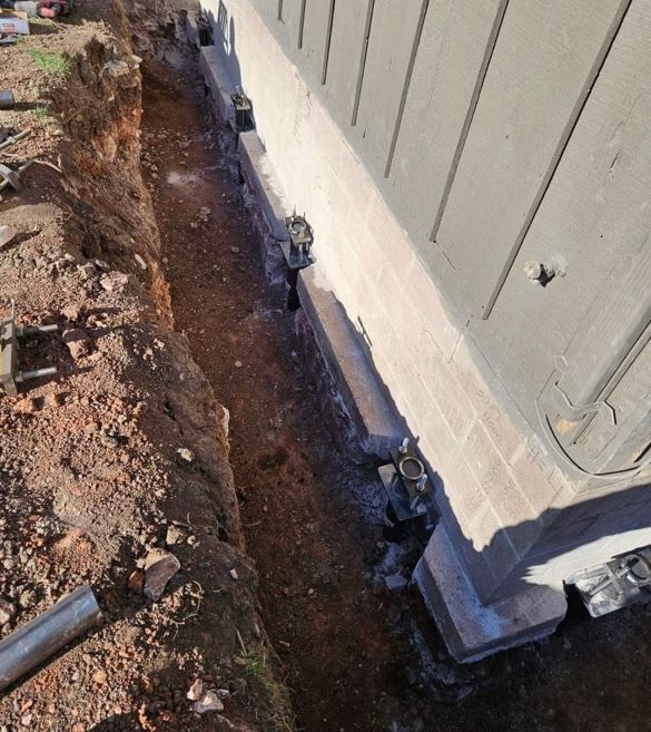 Foundation push piers used to repair a  sunken corner