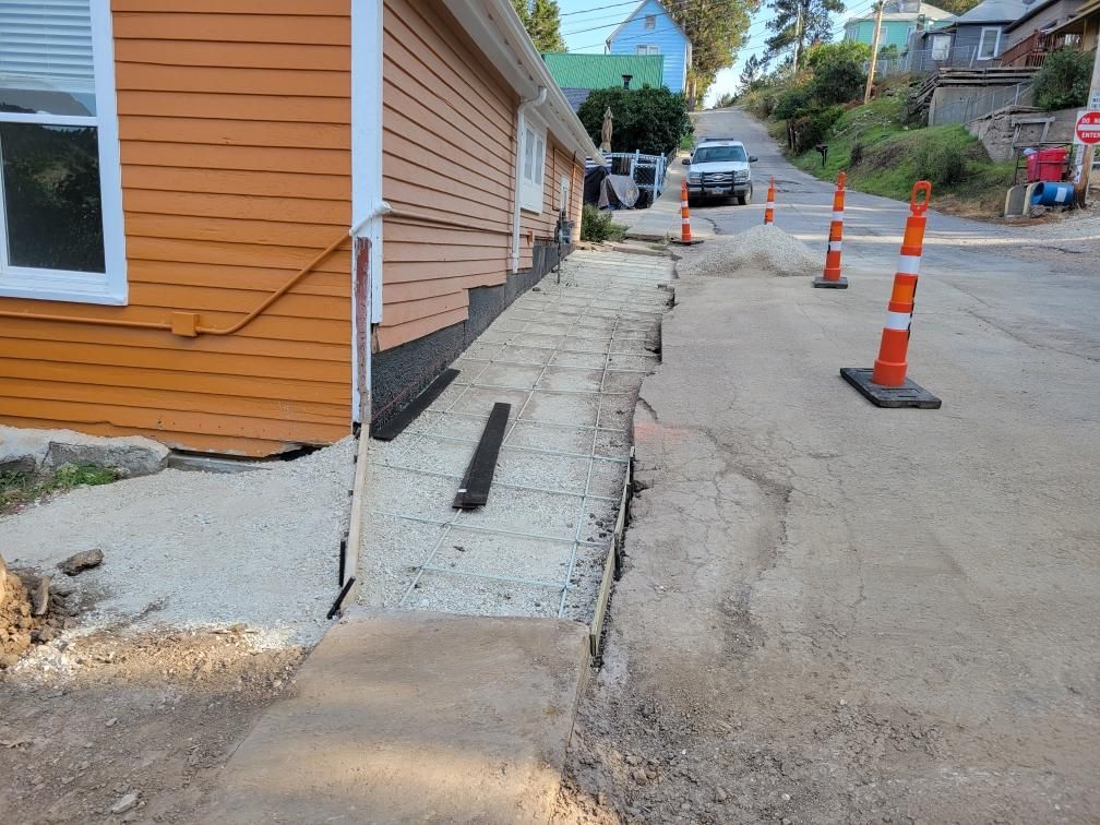 poured concrete against the house to help divert water away from the house