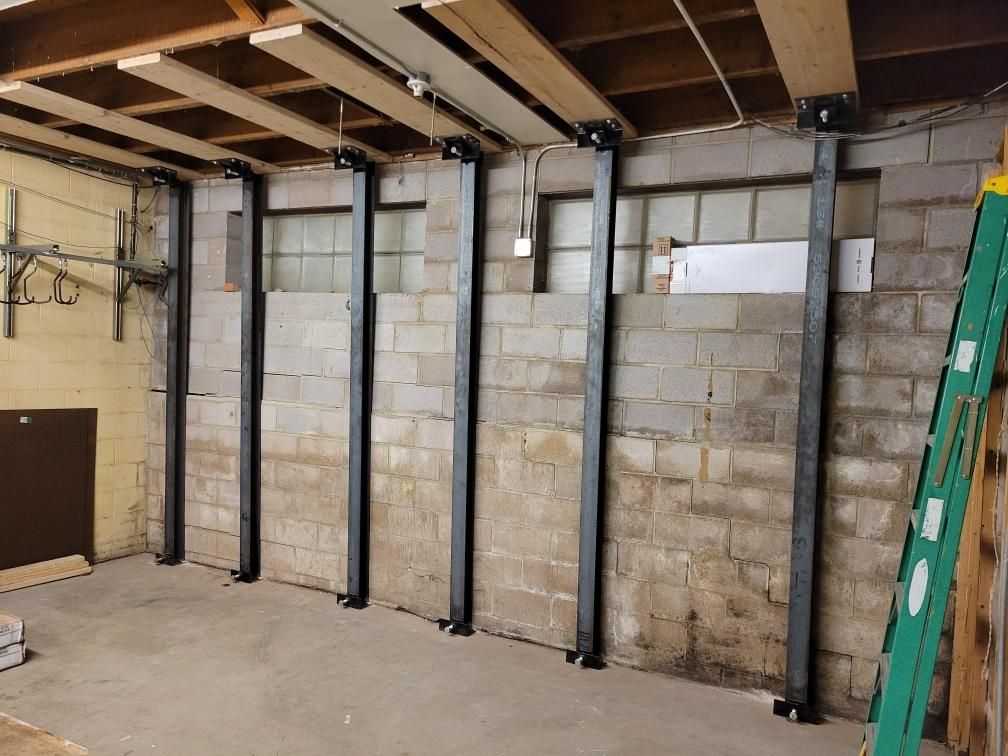 Installed I-beam straps to secure the walls