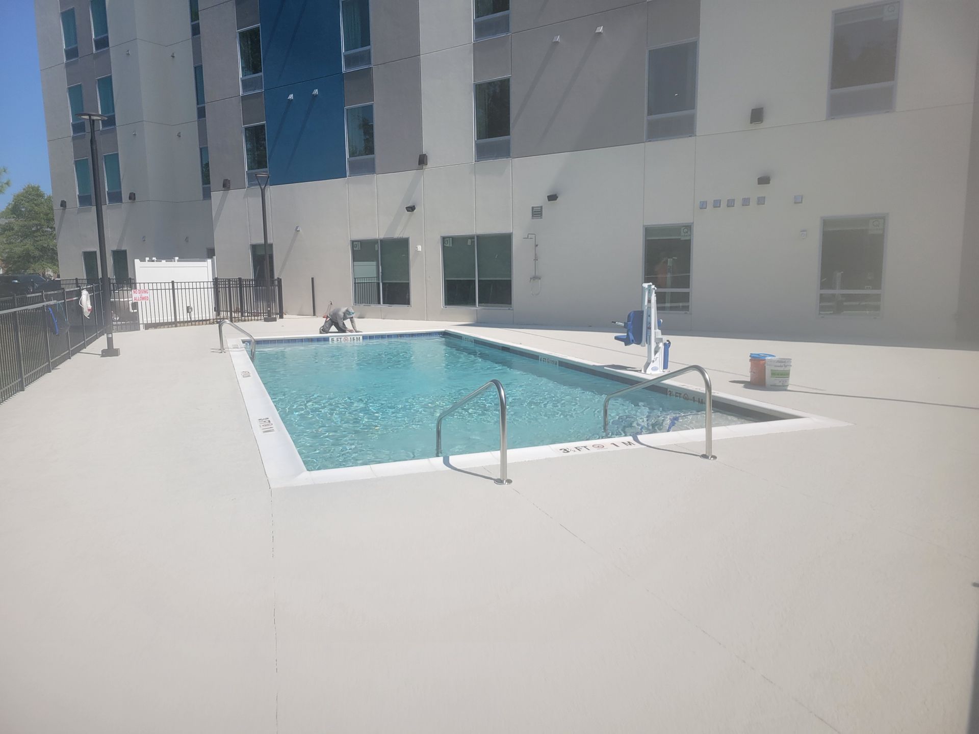 A large swimming pool in front of a building