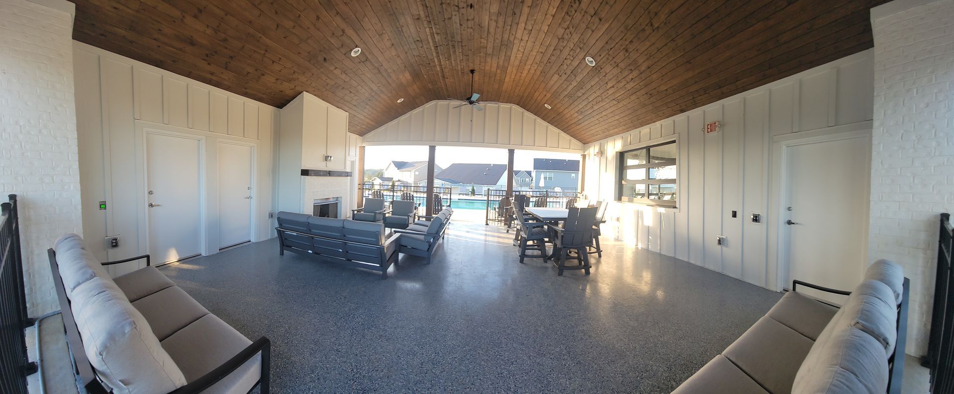 A large room with a lot of furniture and a wooden ceiling.