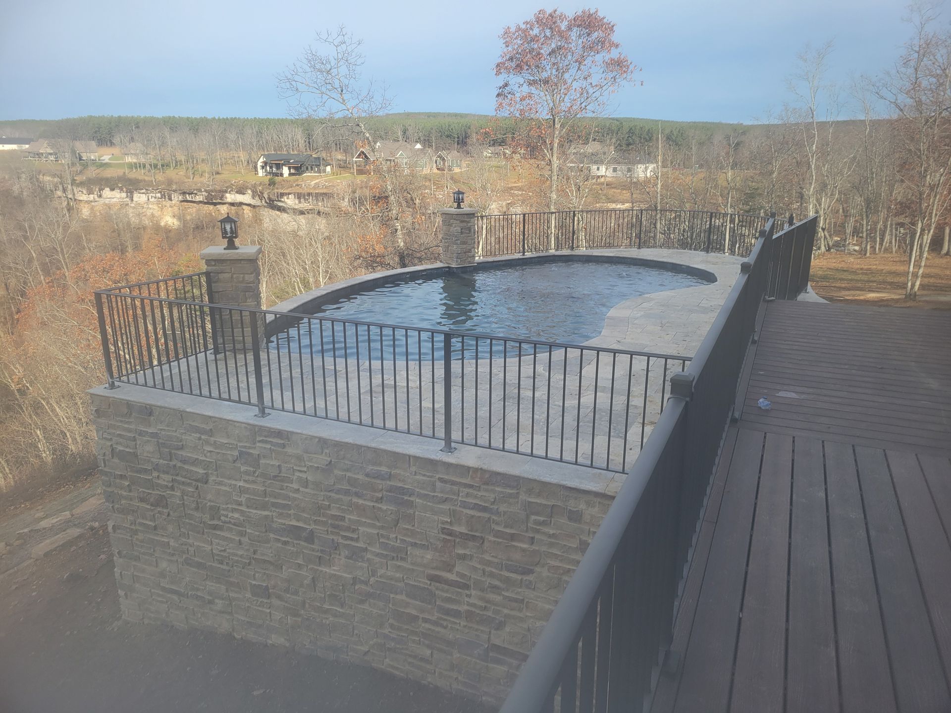 A large swimming pool on top of a wooden deck