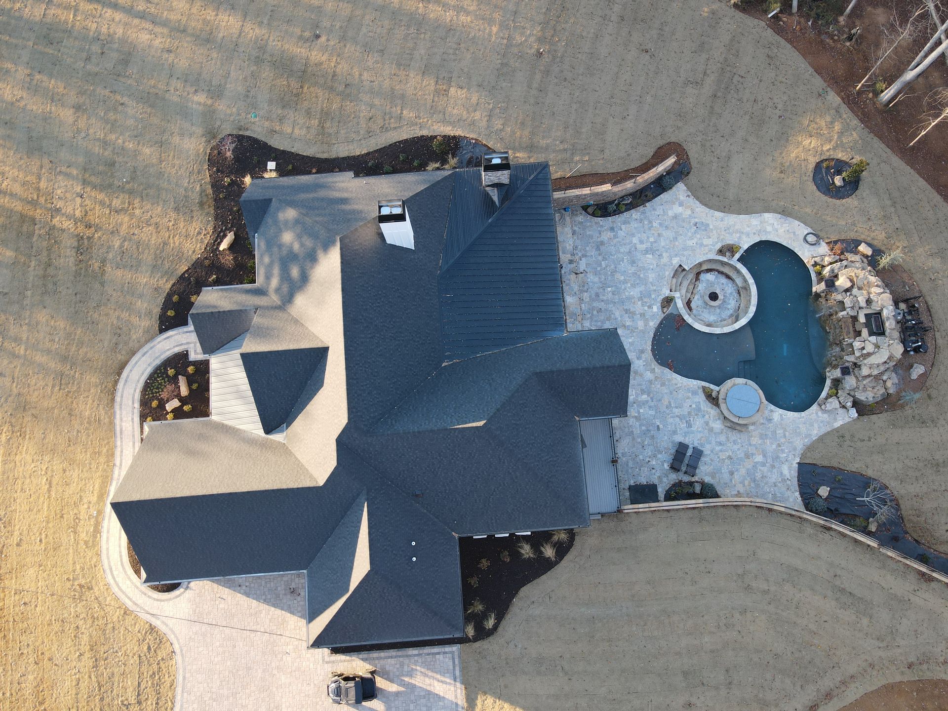 An aerial view of a house with a pool in the backyard