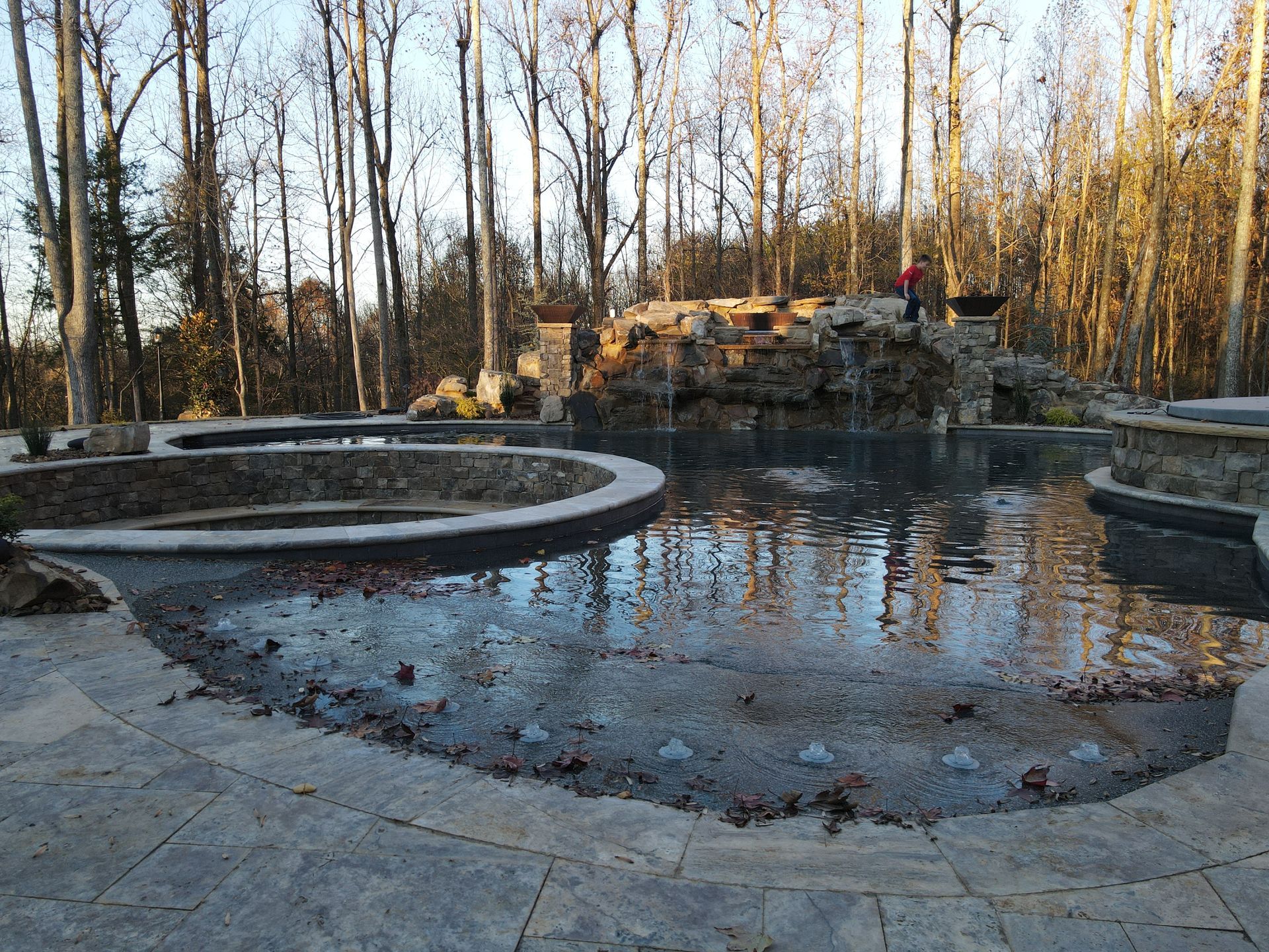 A large swimming pool in the middle of a forest