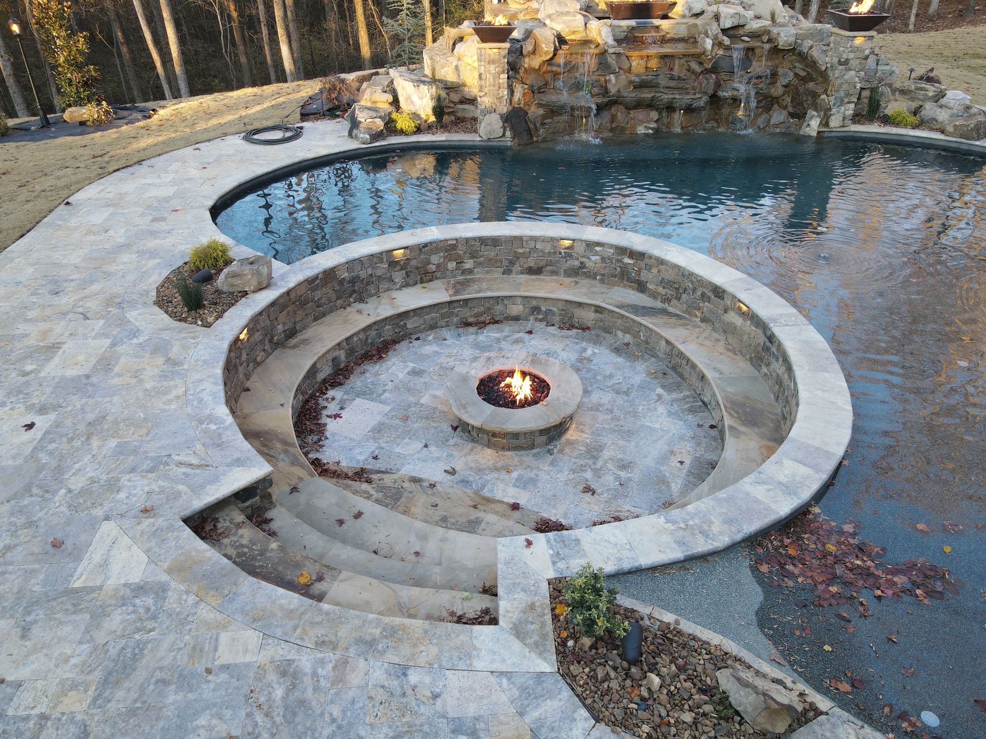 There is a fire pit in the middle of the pool.