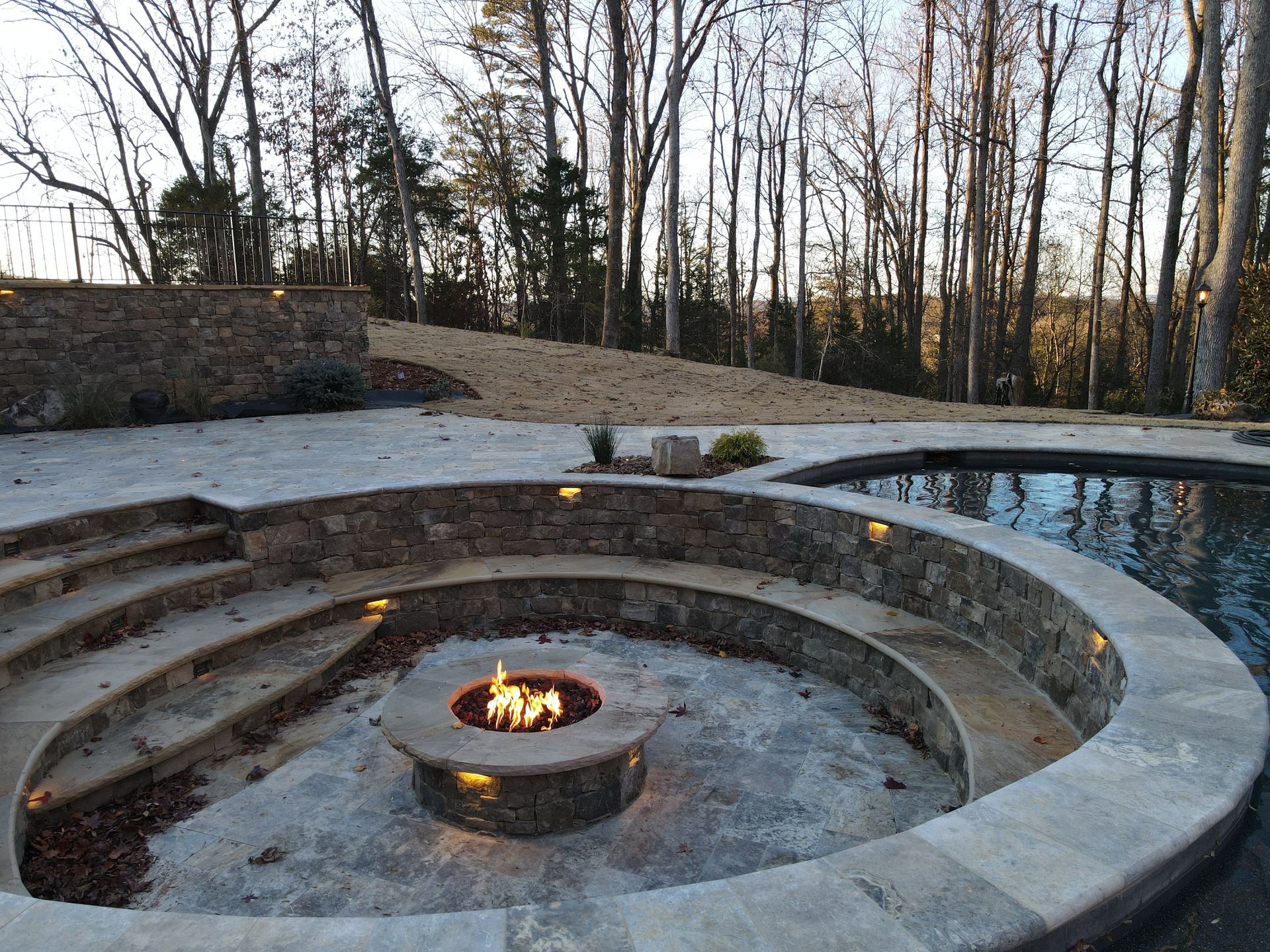 There is a fire pit in the middle of the pool.