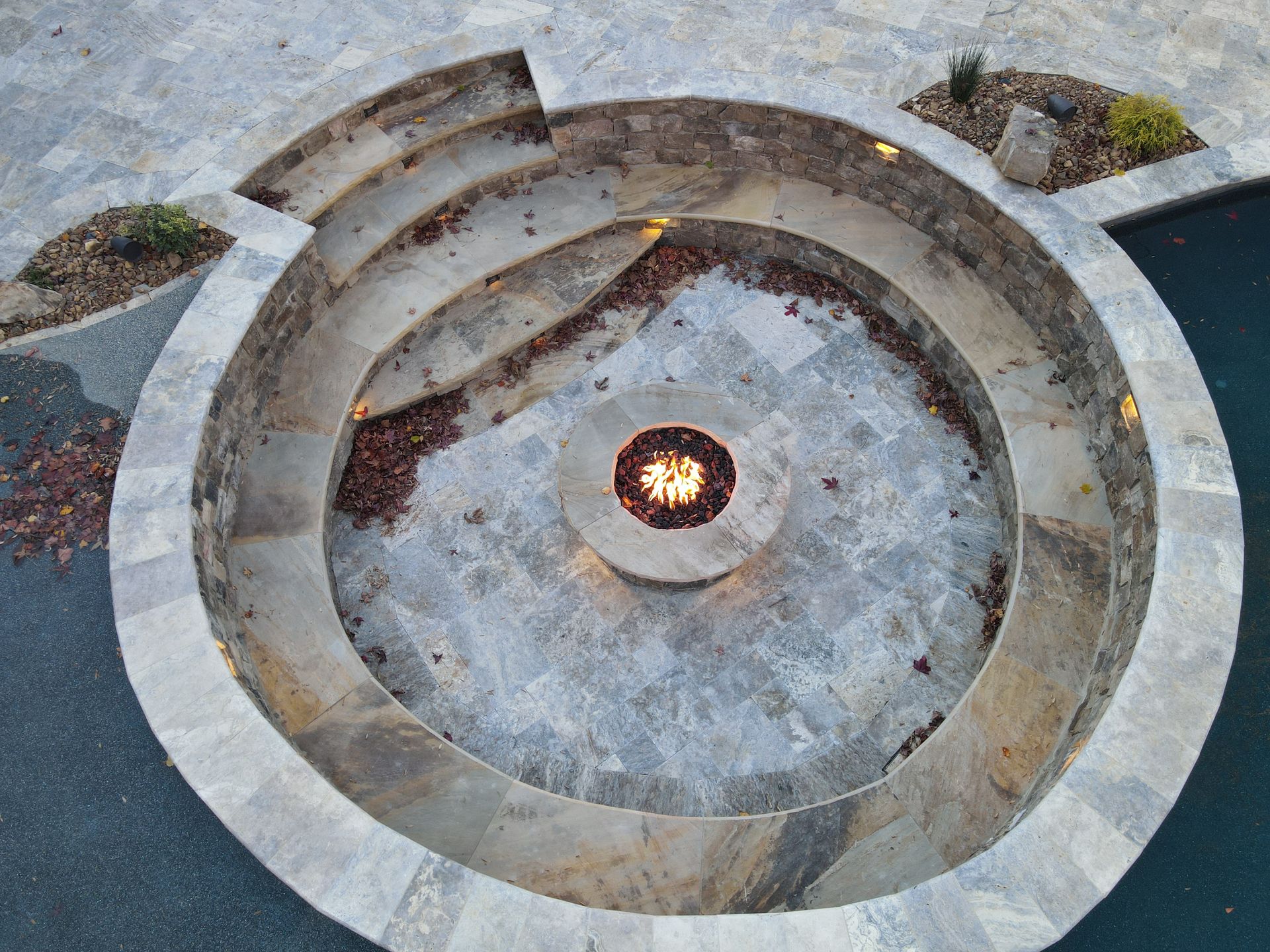An aerial view of a fire pit in the middle of a pool.