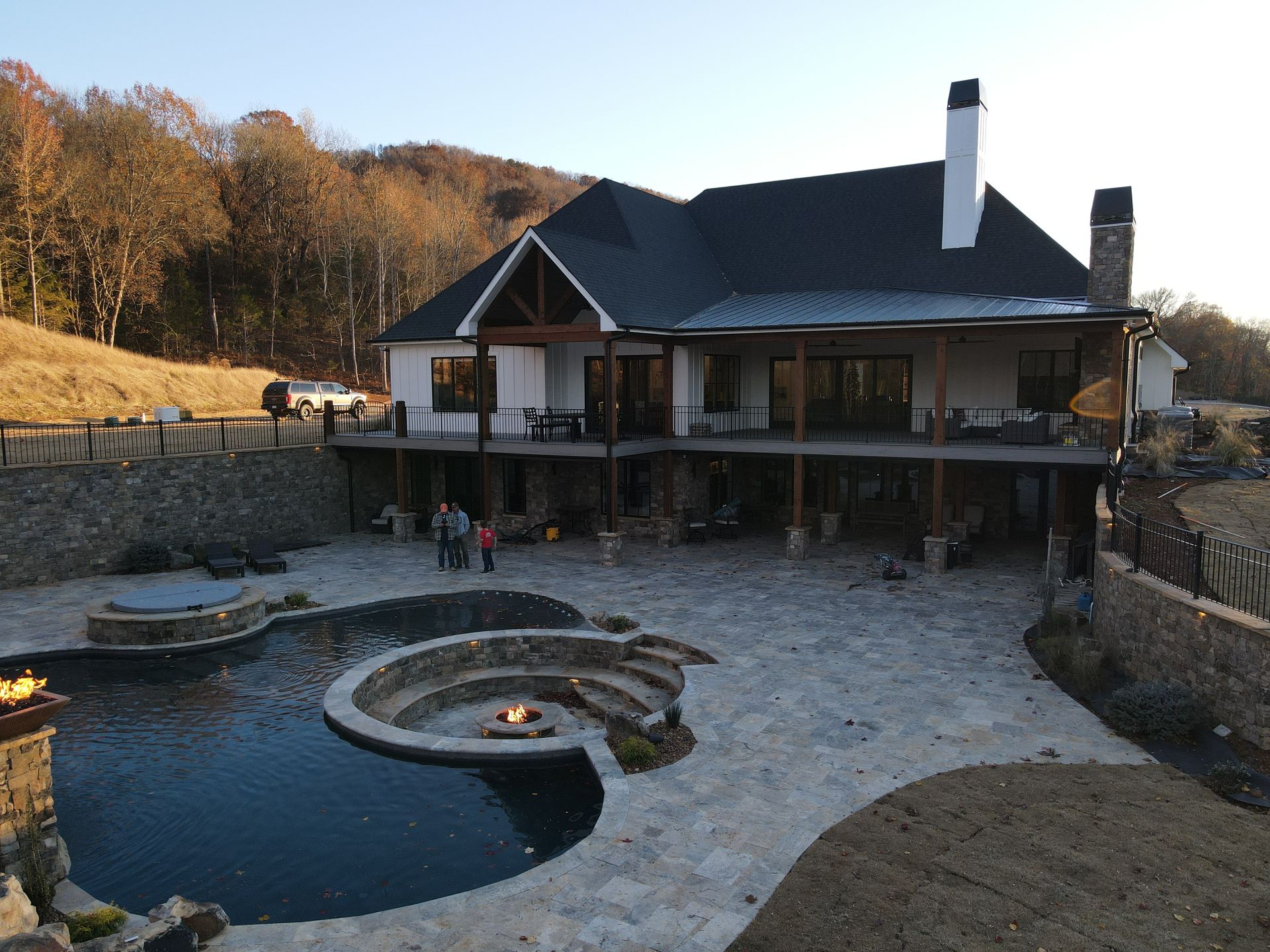 A large house with a large swimming pool in front of it