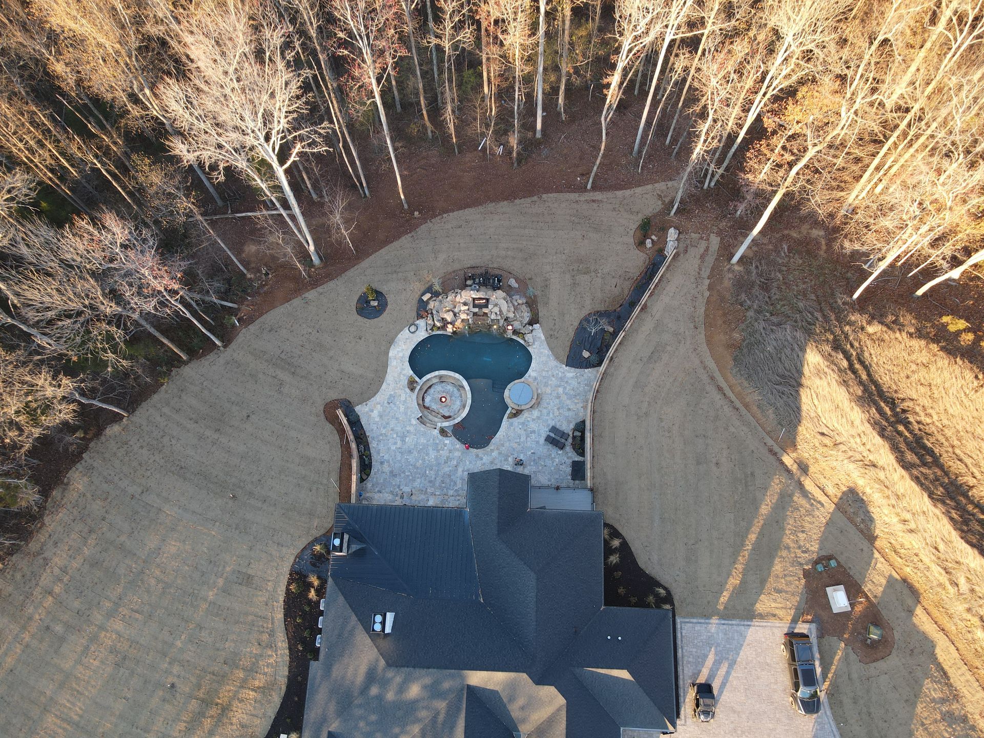 An aerial view of a house with a pool in the backyard