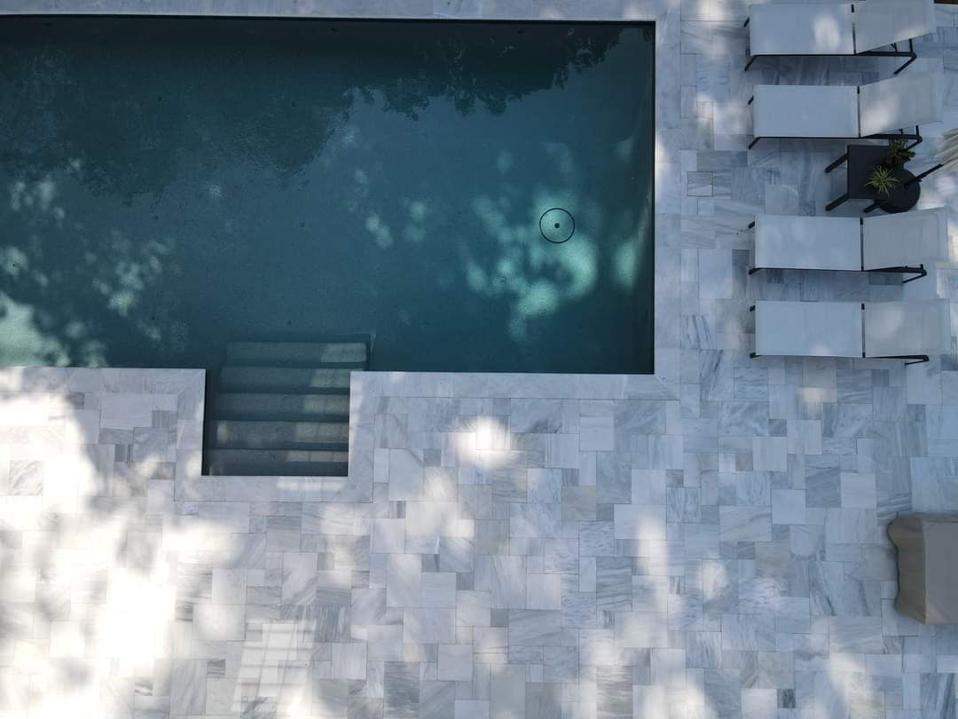 An aerial view of a large swimming pool surrounded by chairs.