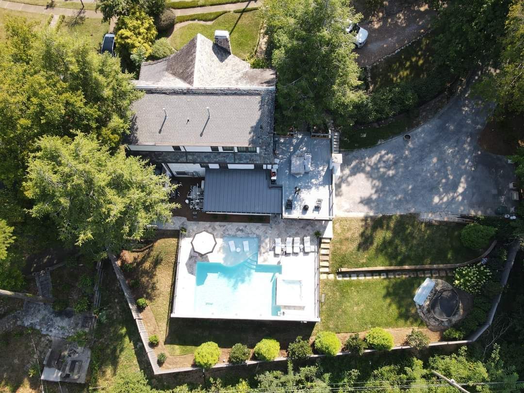 An aerial view of a house with a swimming pool