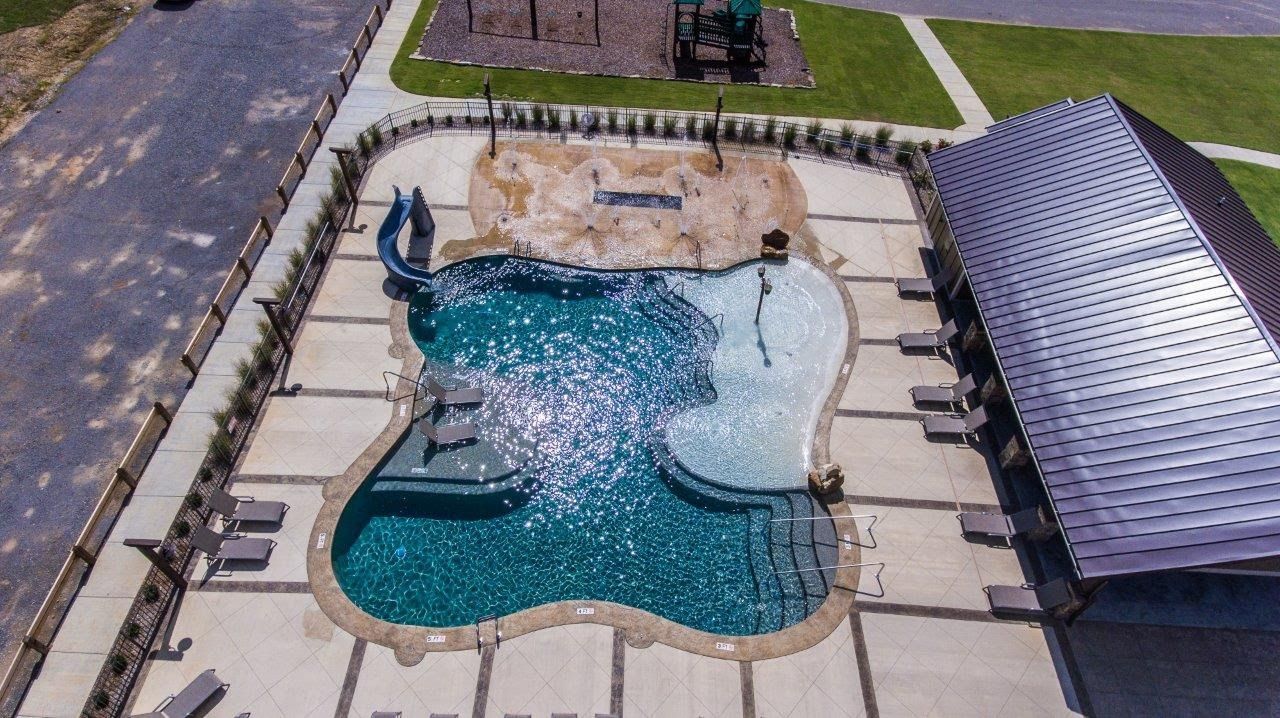 An aerial view of a large swimming pool with a slide
