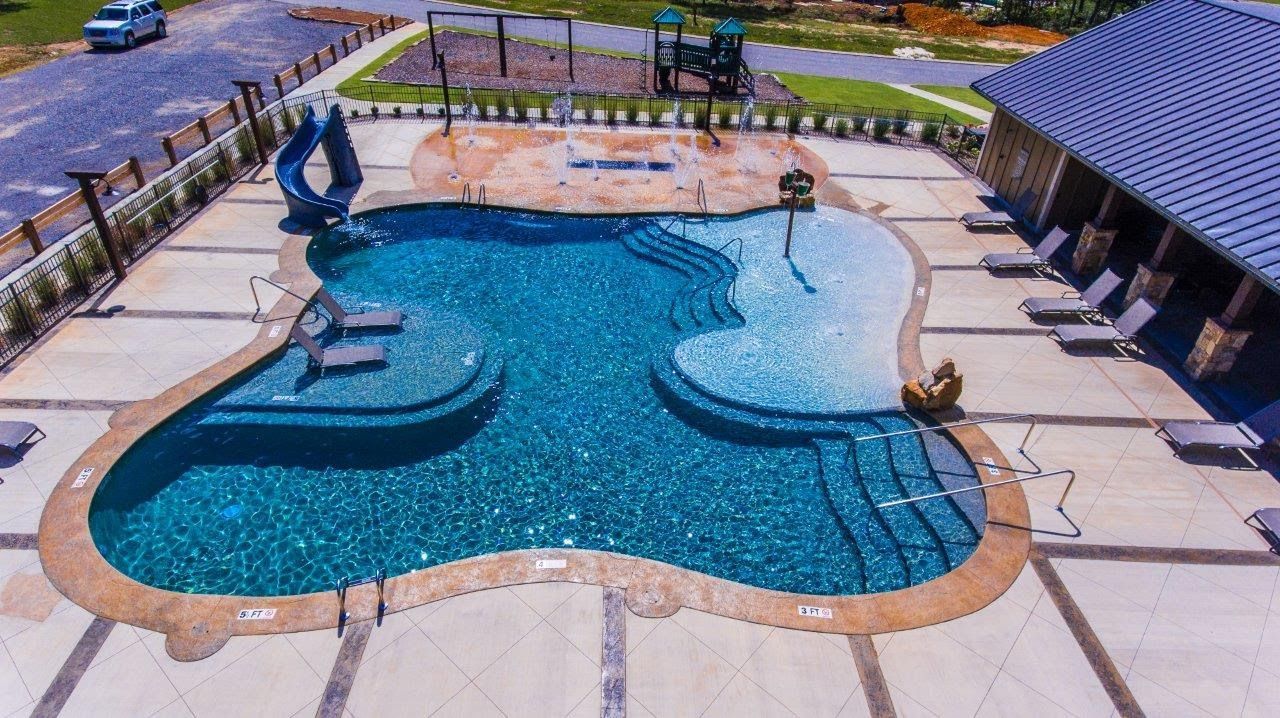 An aerial view of a large swimming pool with a slide