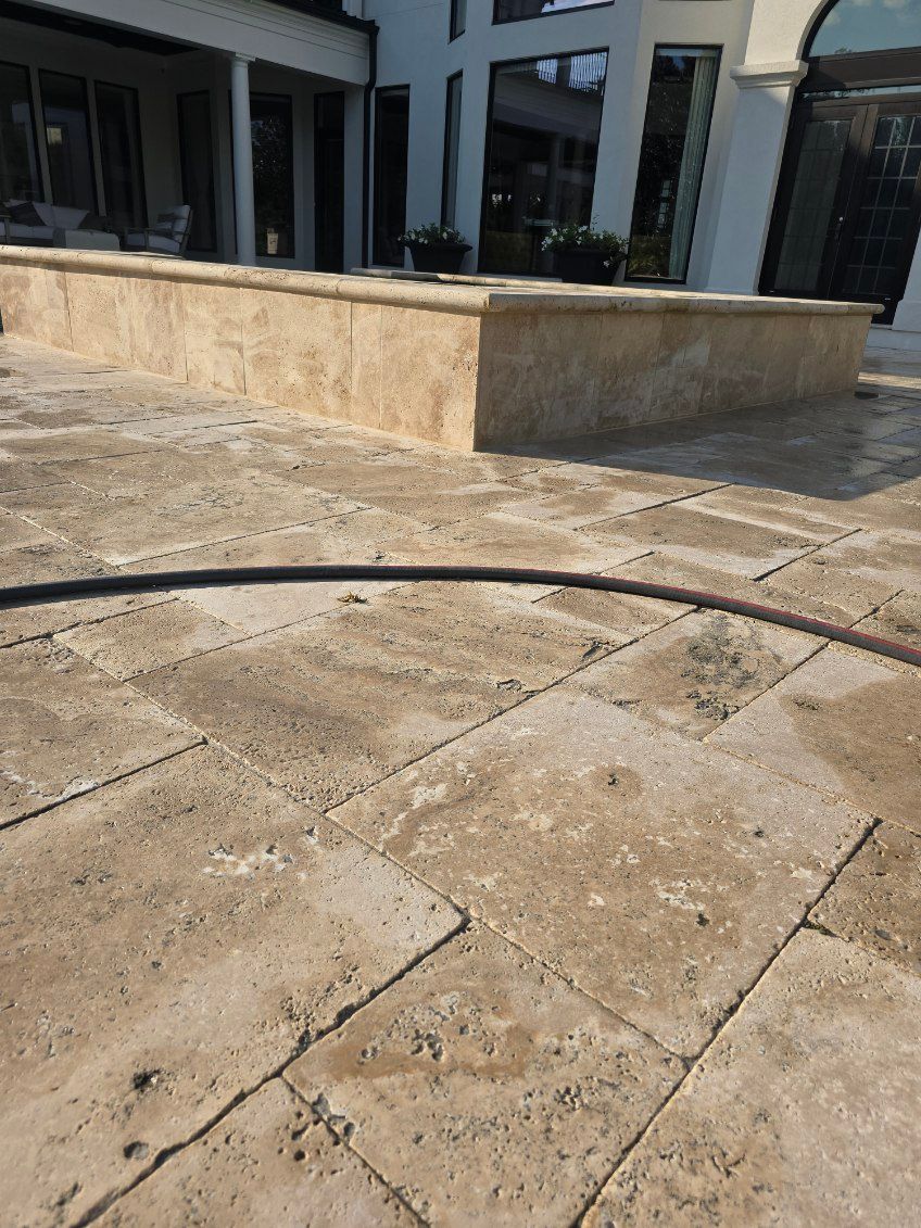 A hose is laying on a tiled floor in front of a building.