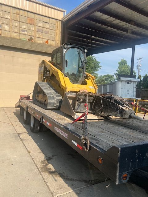A yellow bulldozer is sitting on top of a flatbed trailer.