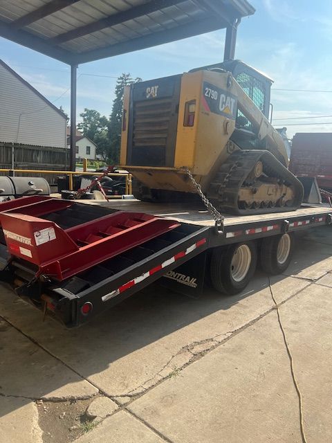 A bulldozer is sitting on top of a trailer.
