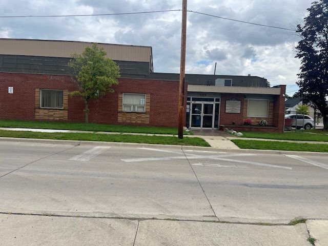 A brick building with a telephone pole in front of it