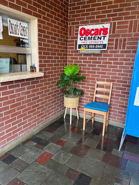 A brick wall with a sign that says oscar 's cement