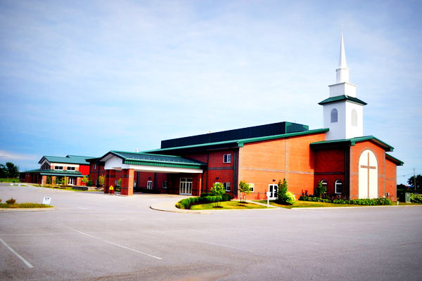 A large red brick church with a white steeple