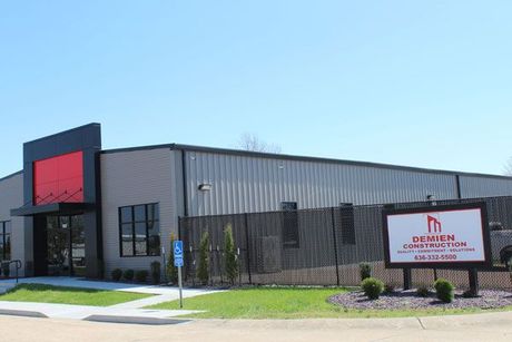 A large building with a sign in front of it.