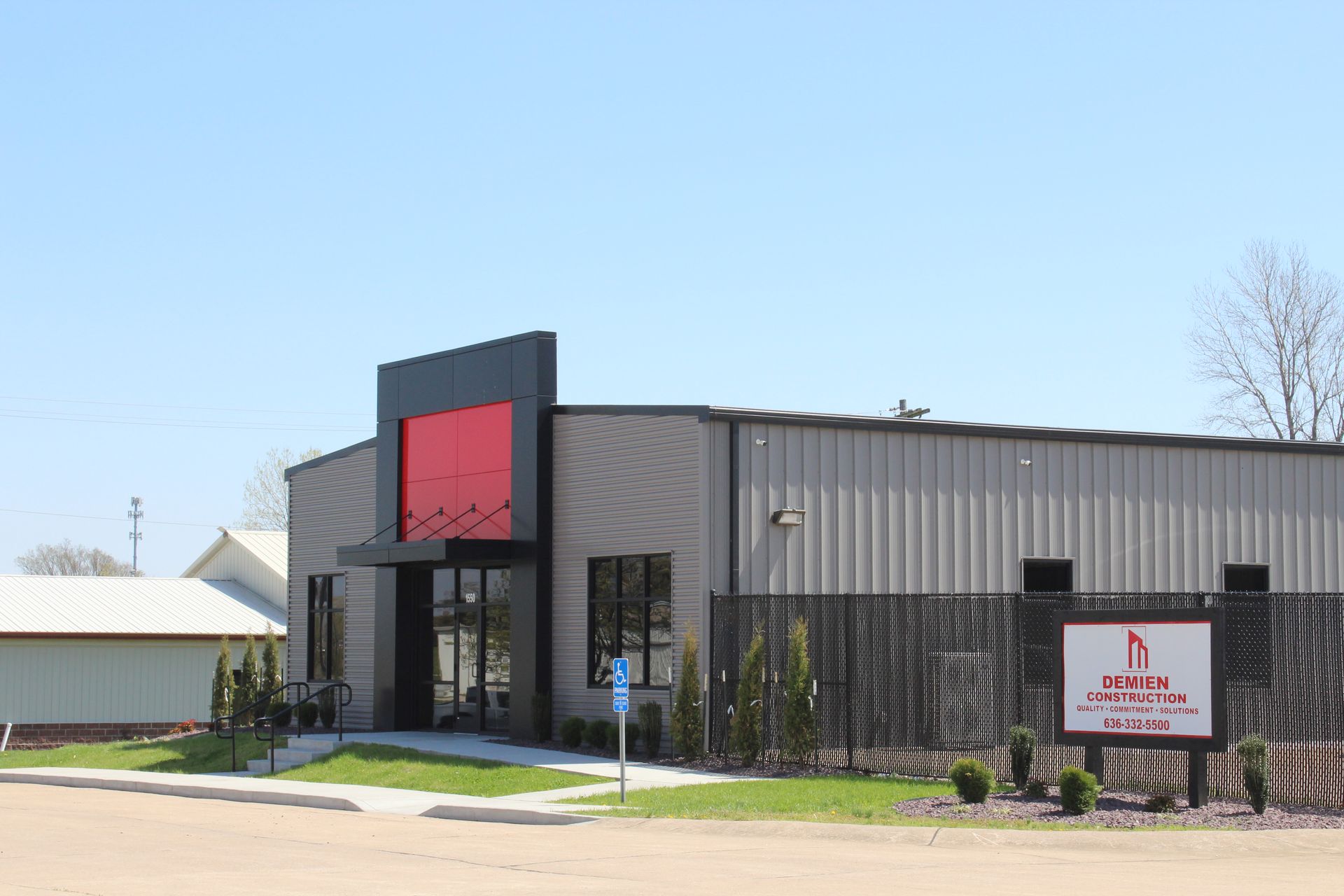 A large building with a red sign on the side of it.