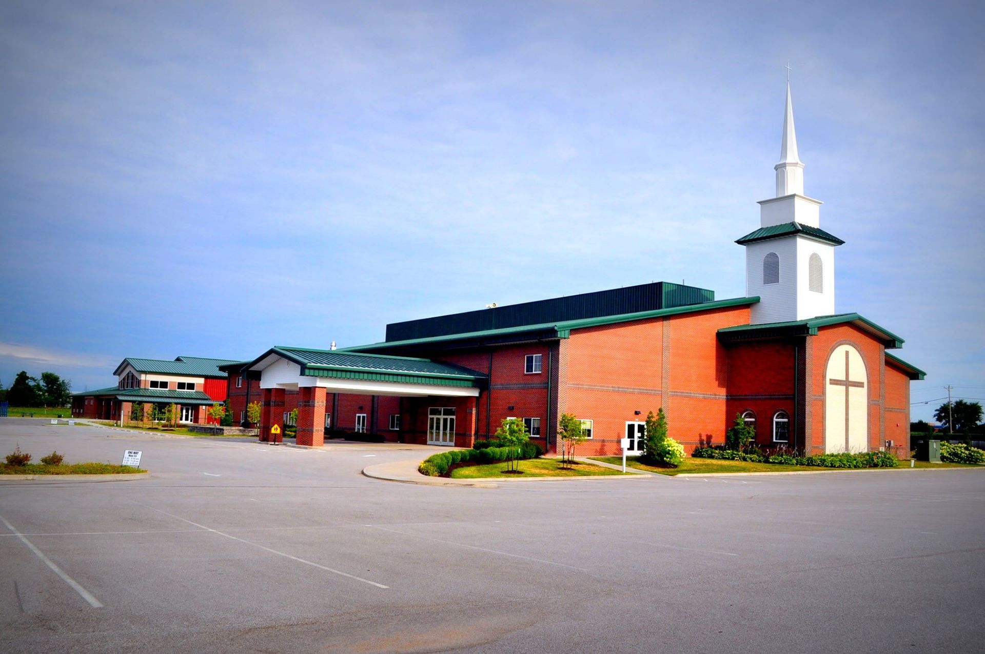 A large brick church with a white steeple