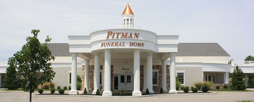 A large white building with the word pitman on it