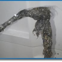 Metallic foil-wrapped duct protruding from a white wall and ceiling corner