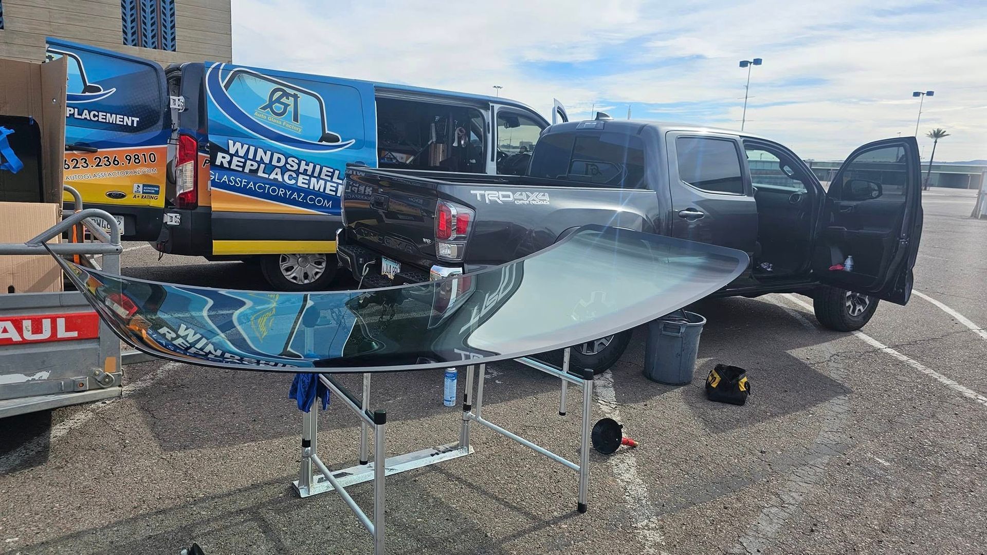 A truck is parked in a parking lot next to a van.