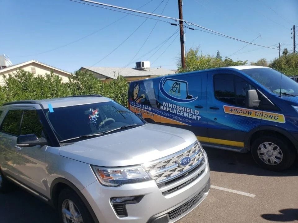 Two cars are parked next to each other in a parking lot.