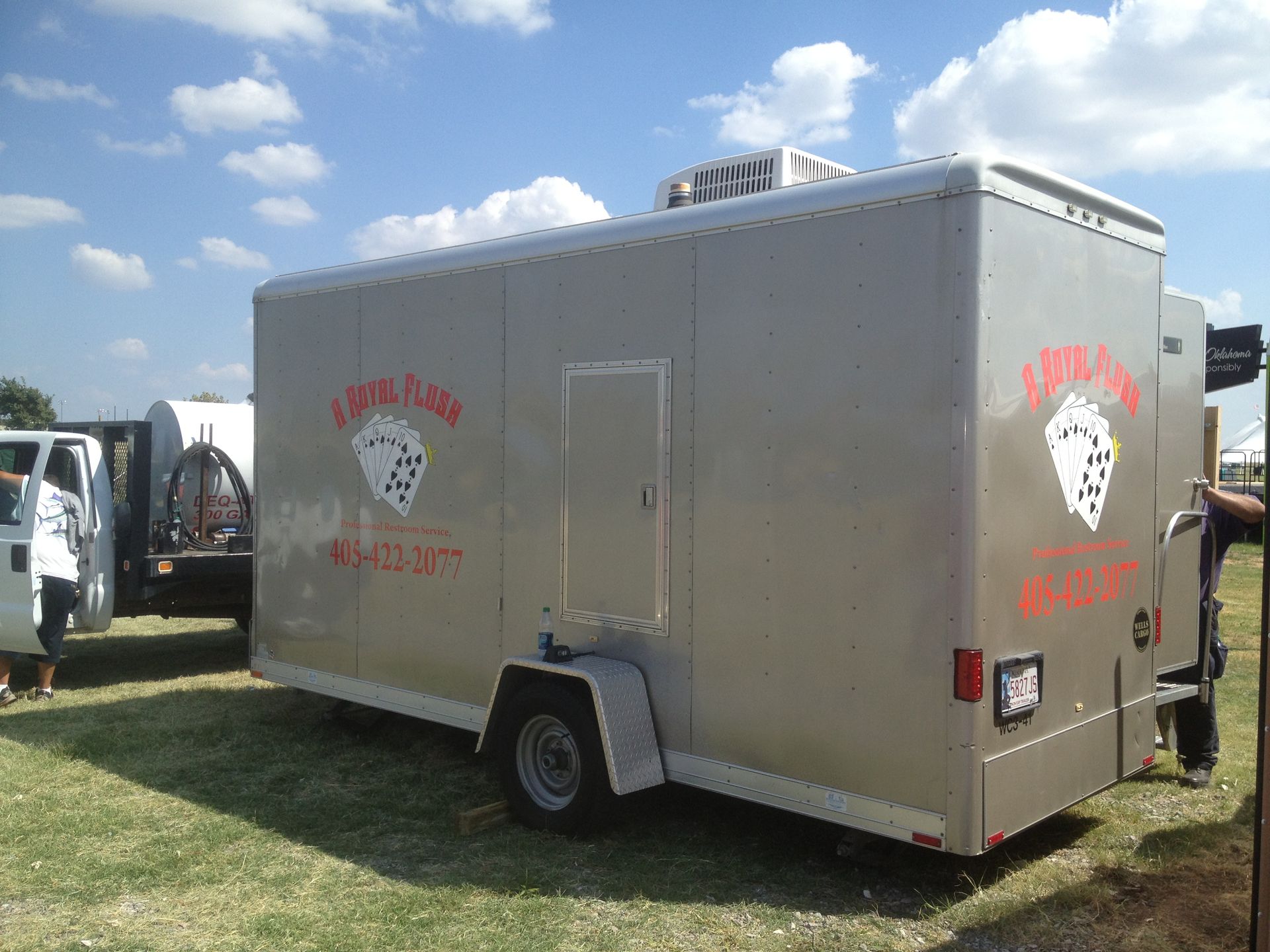 Gray food trailer with red logo, 