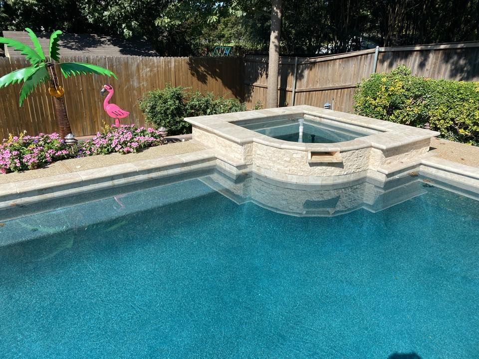 A large swimming pool with a flamingo statue and a palm tree.