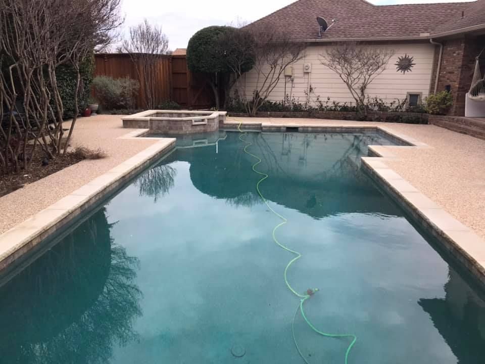 A large swimming pool in the backyard of a house
