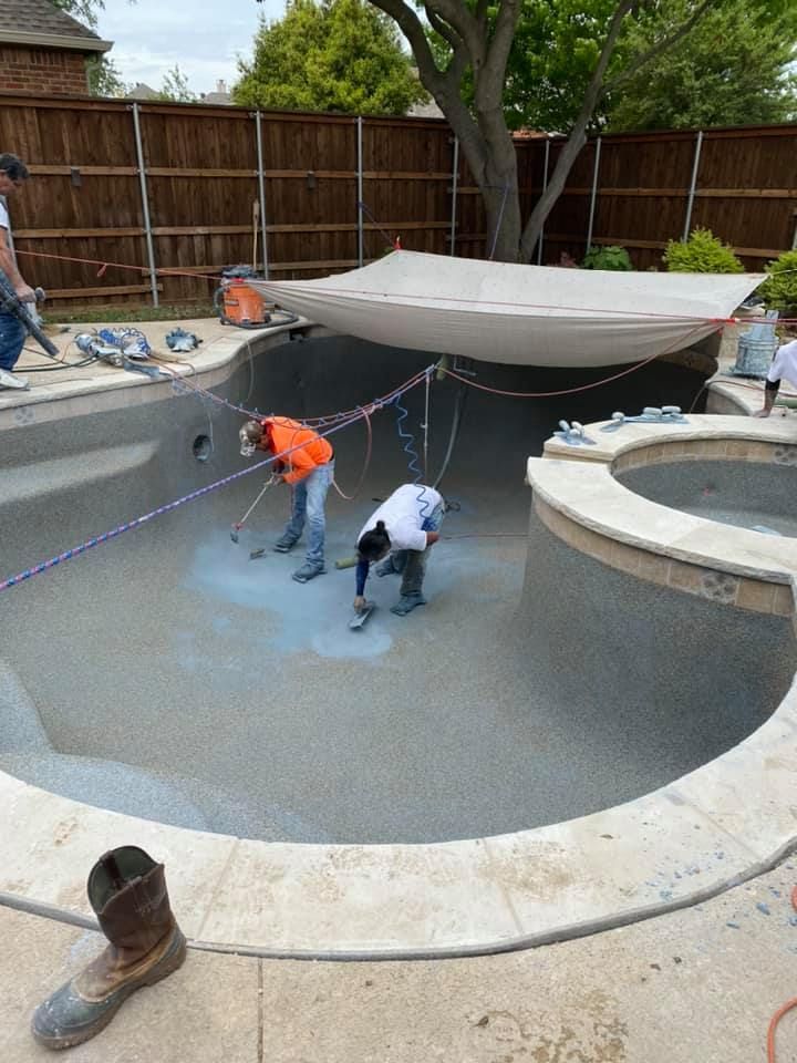 A group of people are working on a swimming pool.