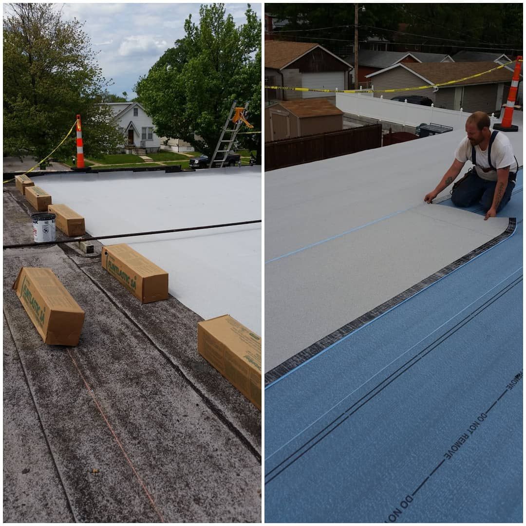 Roofing crew installing white roof membrane on a flat rooftop with tools and weighted blocks