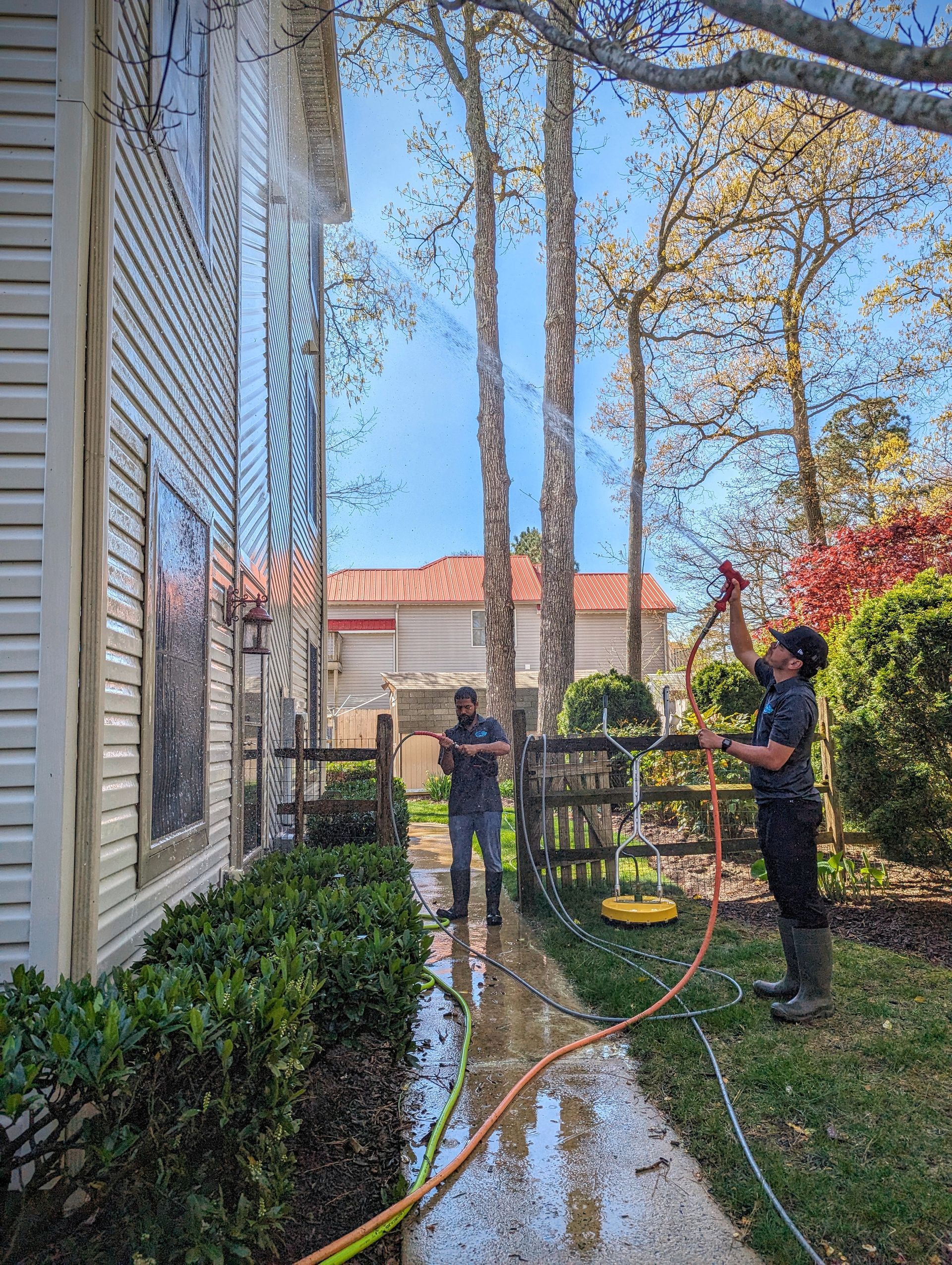 a man standing on a ladder in front of a large house
