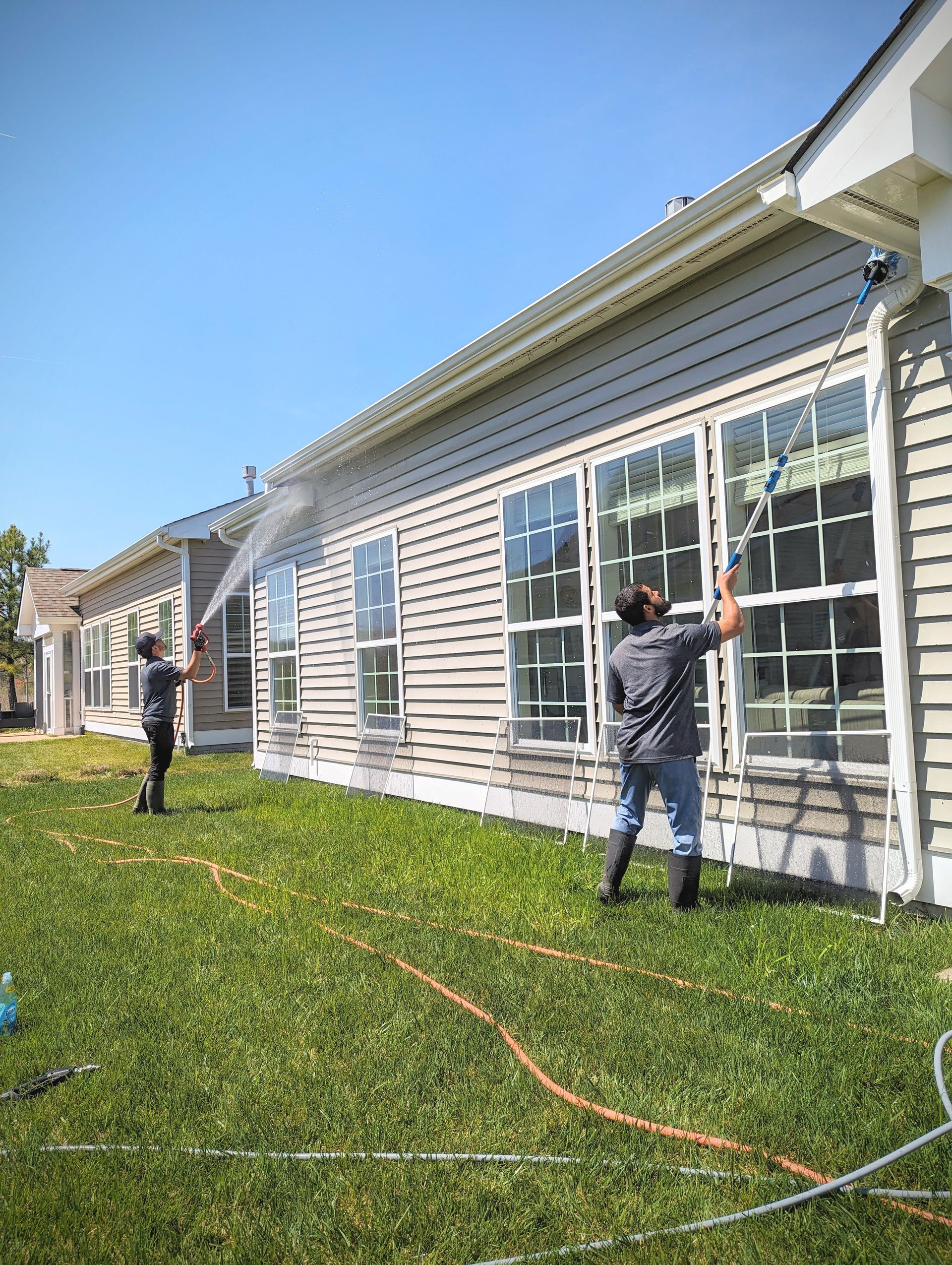 a man is spraying water from a crane in a parking lot