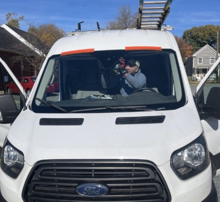 Advertisement for mobile glass repair services with photos of workers, services listed: residential, commercial, auto, and fleet.