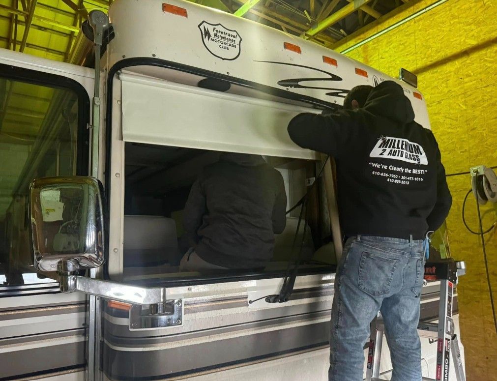 White Ford Maverick truck with black accents and wheels; American flag in the background.