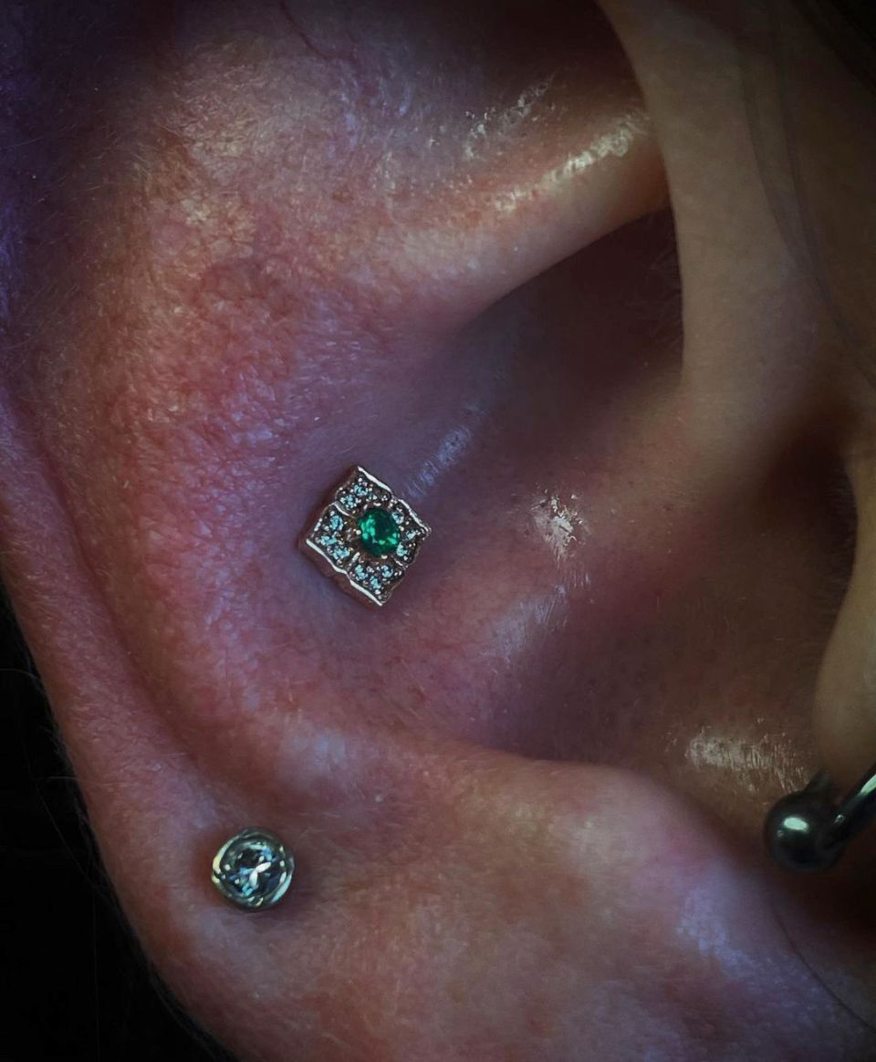 A close-up of a person's ear with earrings