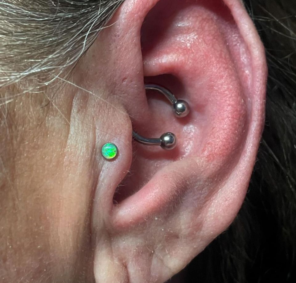 A close-up of a woman's ear with a piercing