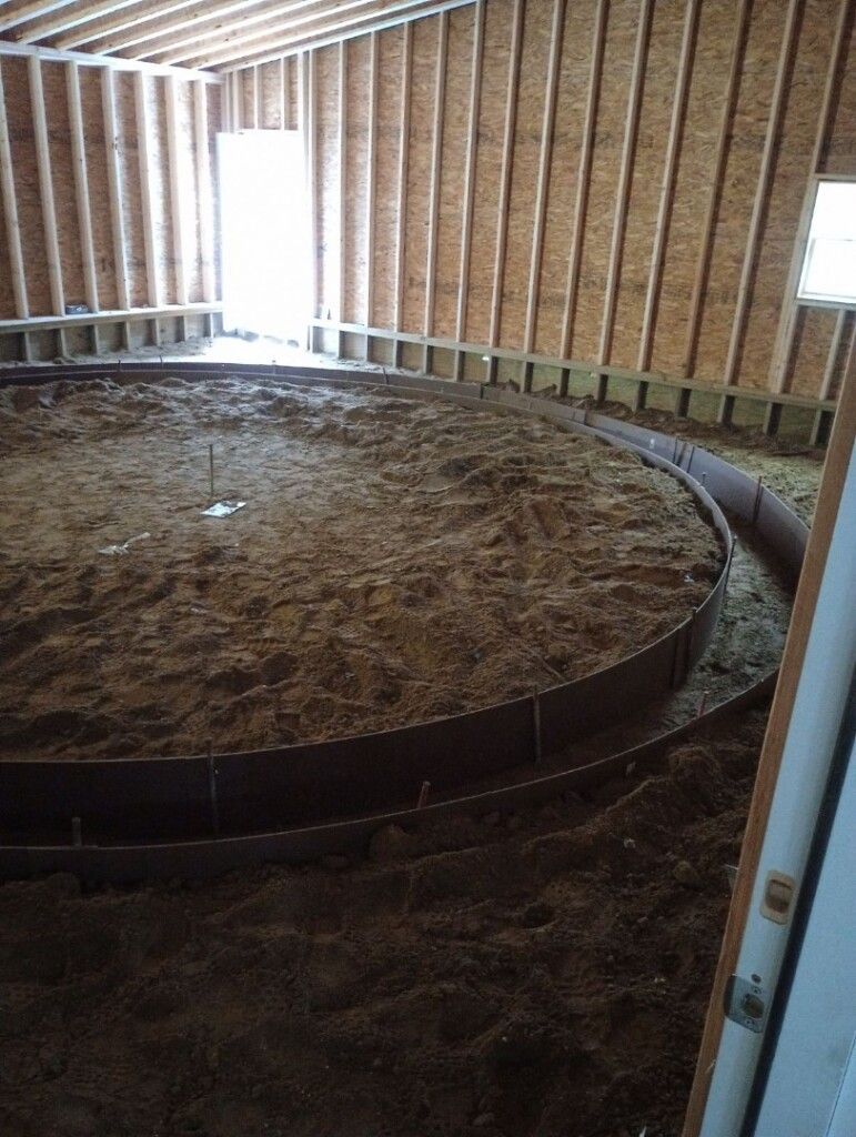 a room with a circle of dirt in the middle of it
