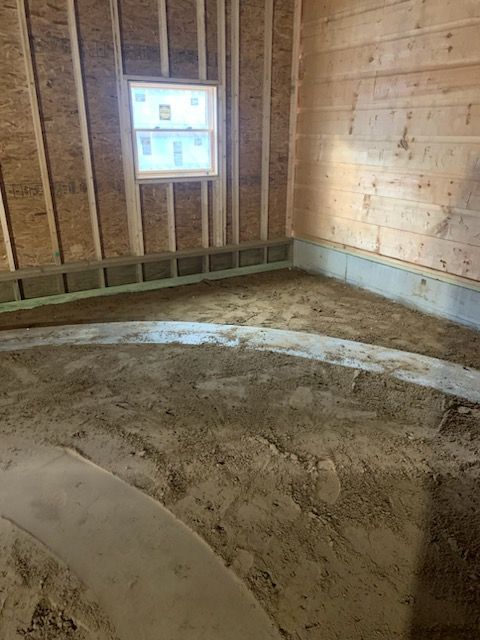 a room with a window and a lot of dirt on the floor