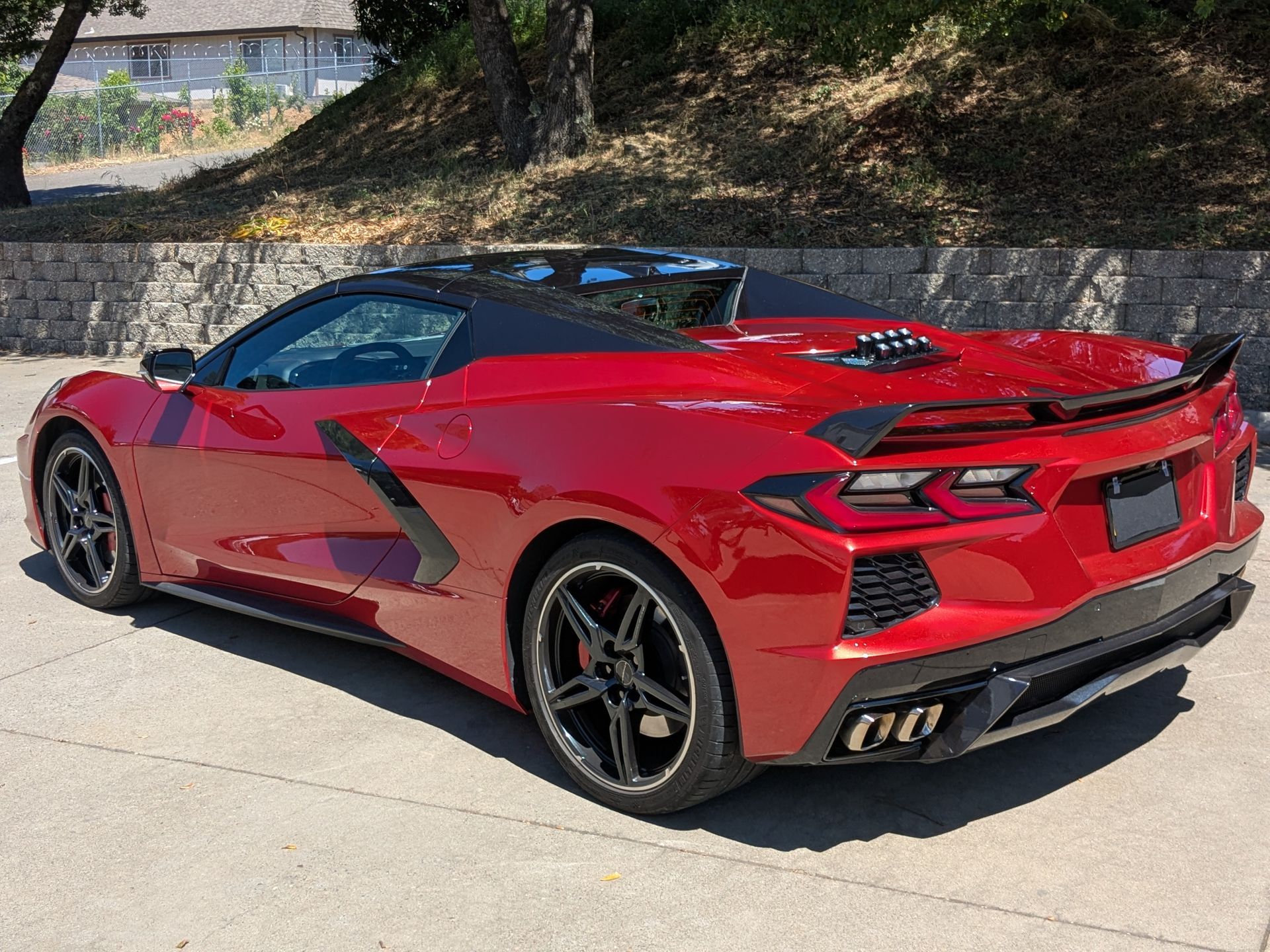 A red sports car is parked on the side of the road.