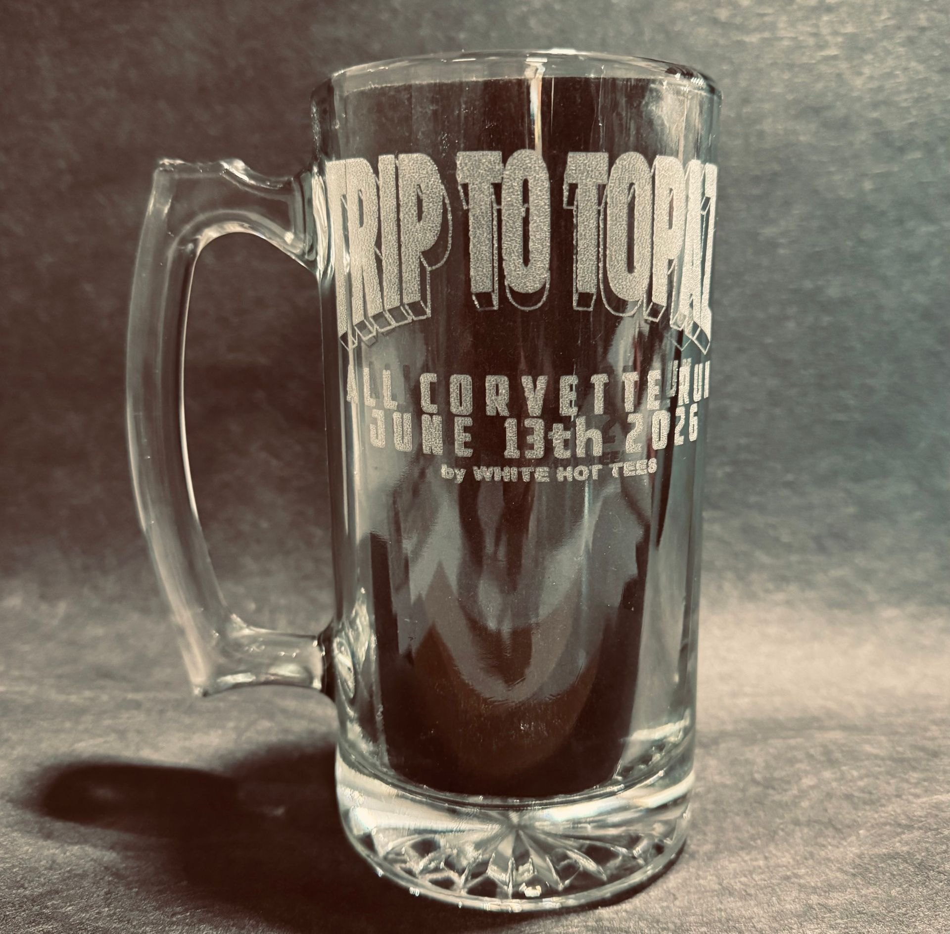 Clear glass beer mug with etched text