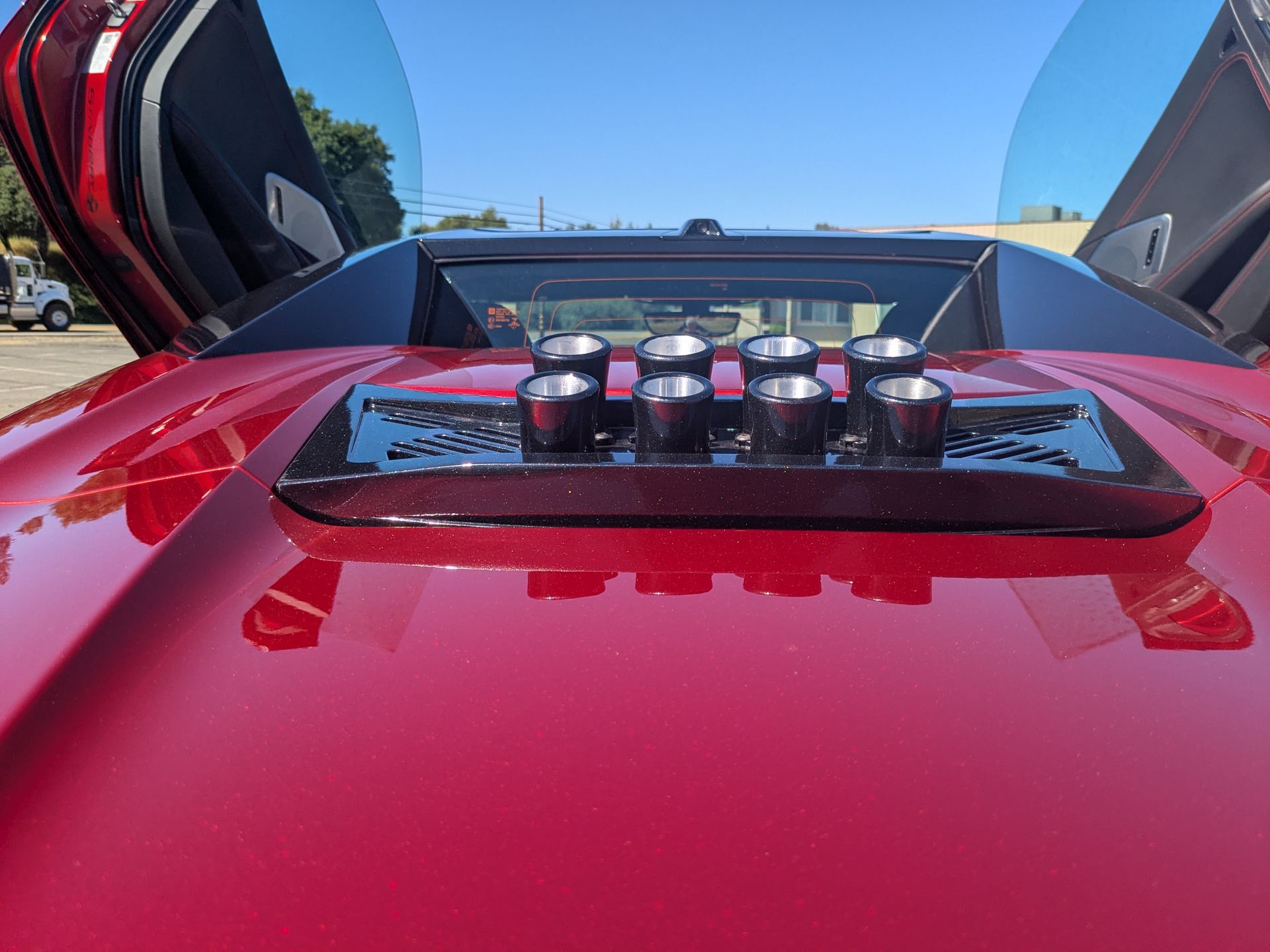 A close up of a red car with the hood open