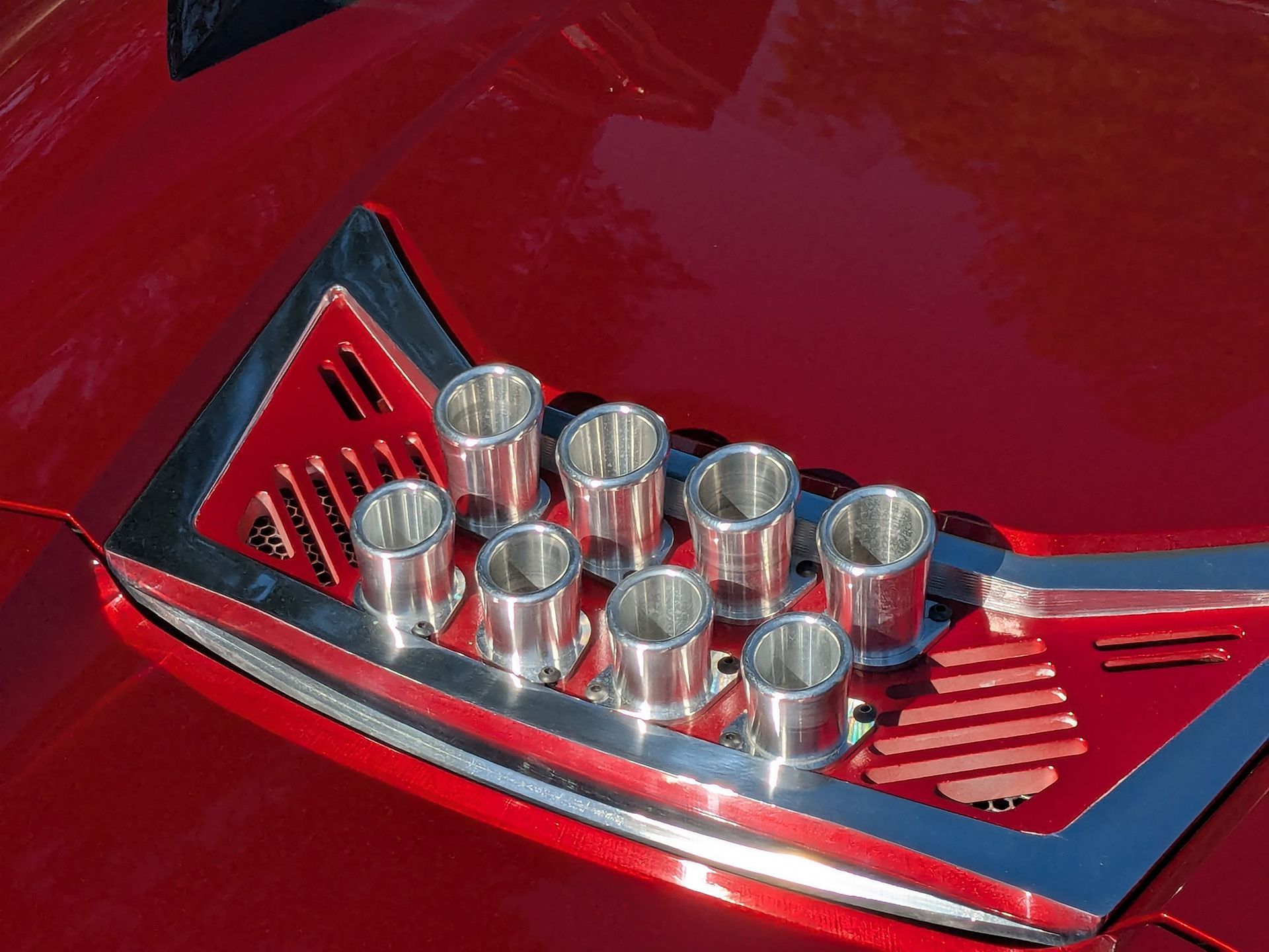 A red car with a chrome trim