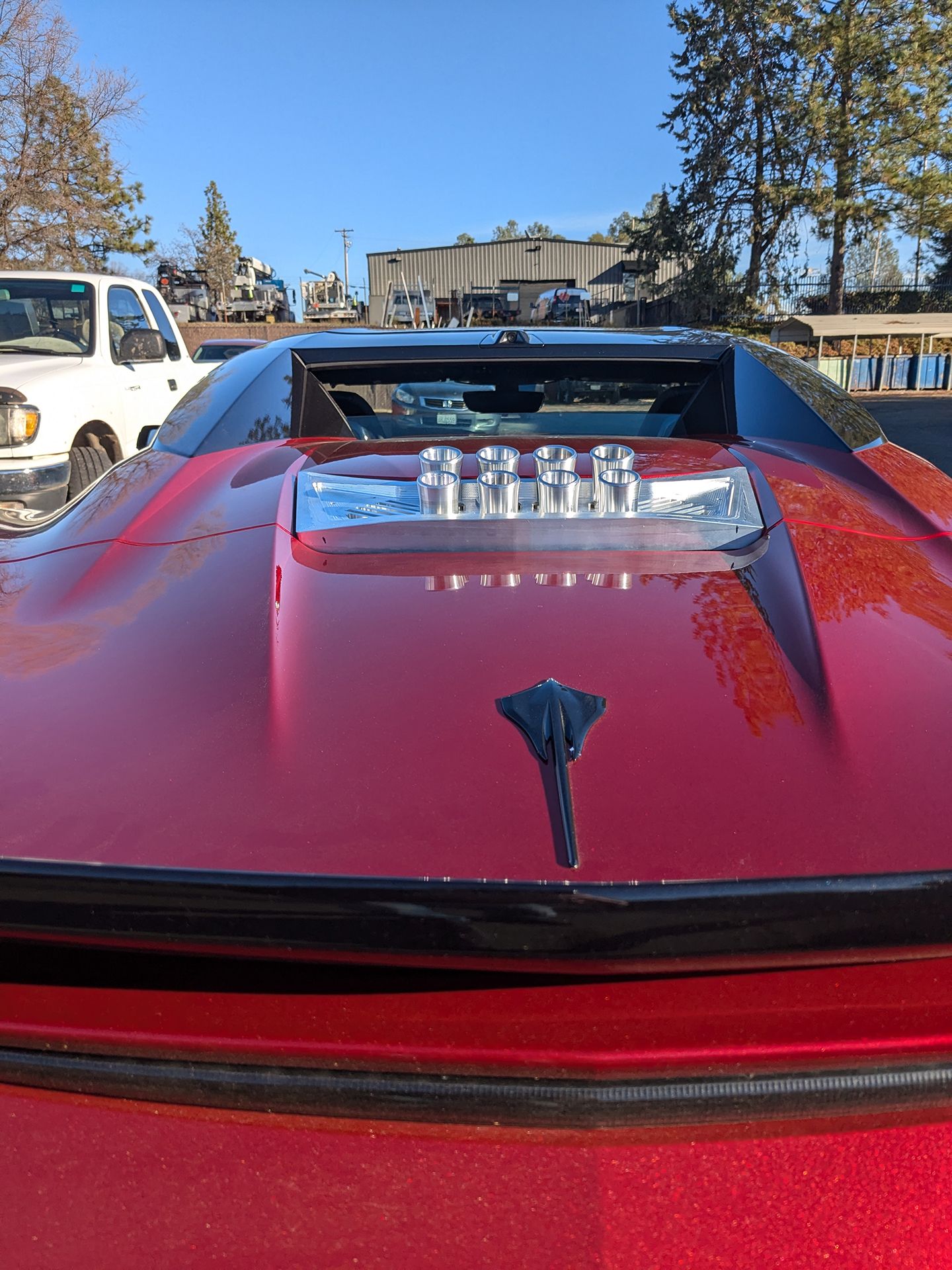 A red sports car with a hood scoop