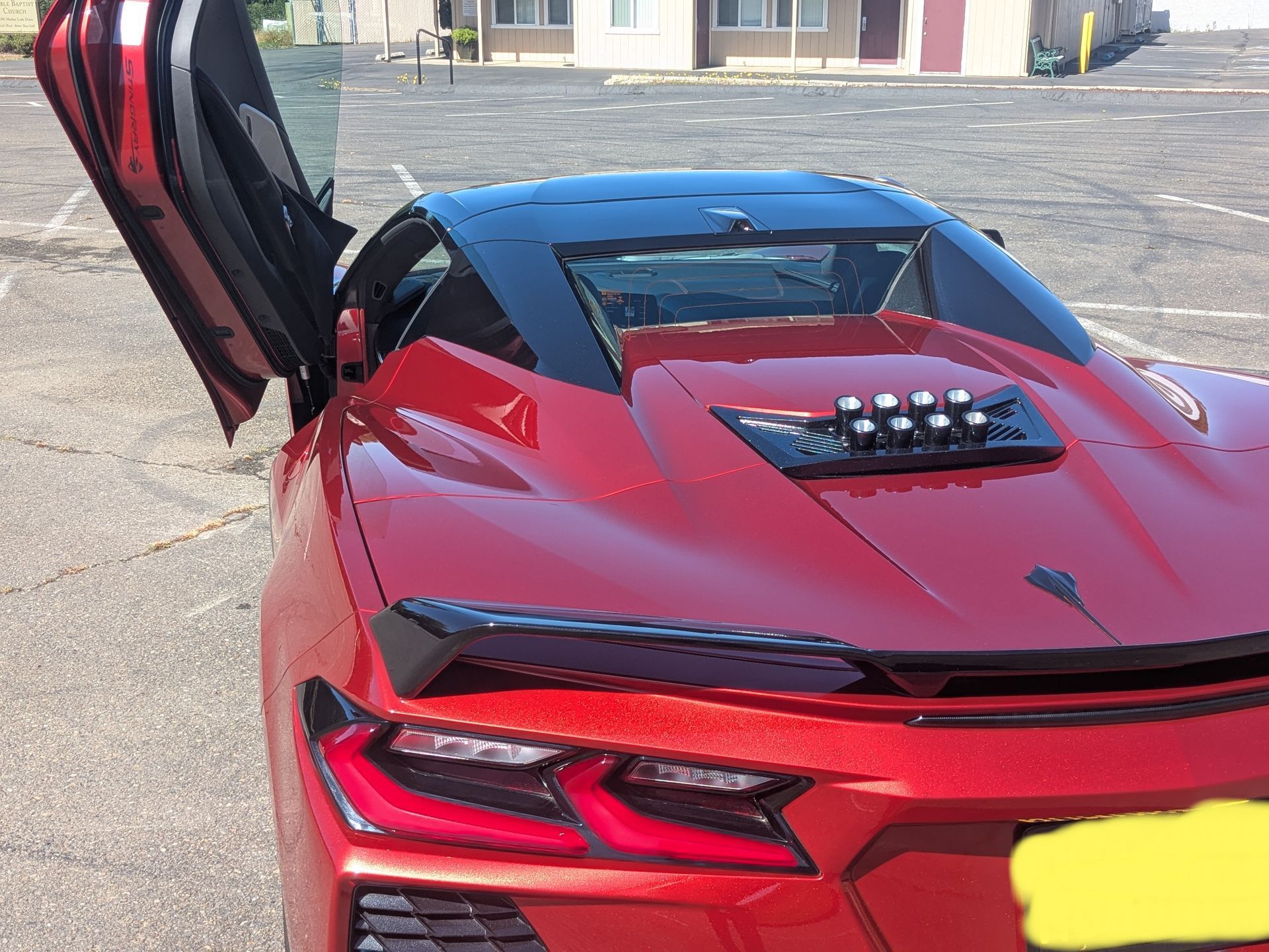 A red sports car with a license plate